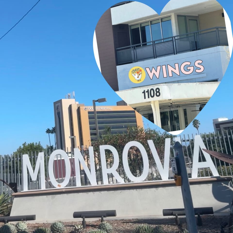 A heart-shaped inset shows the "Shlap Muan Wings" sign on a building, with a "MONROVIA" sign below.